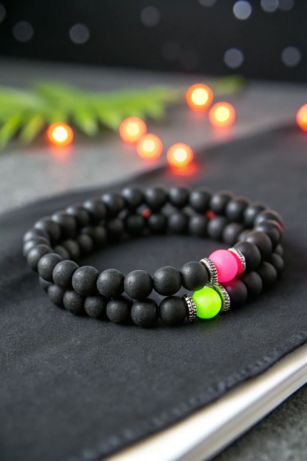 Glow-style clay bead bracelet stack in charcoal and black with bold neon accent pops