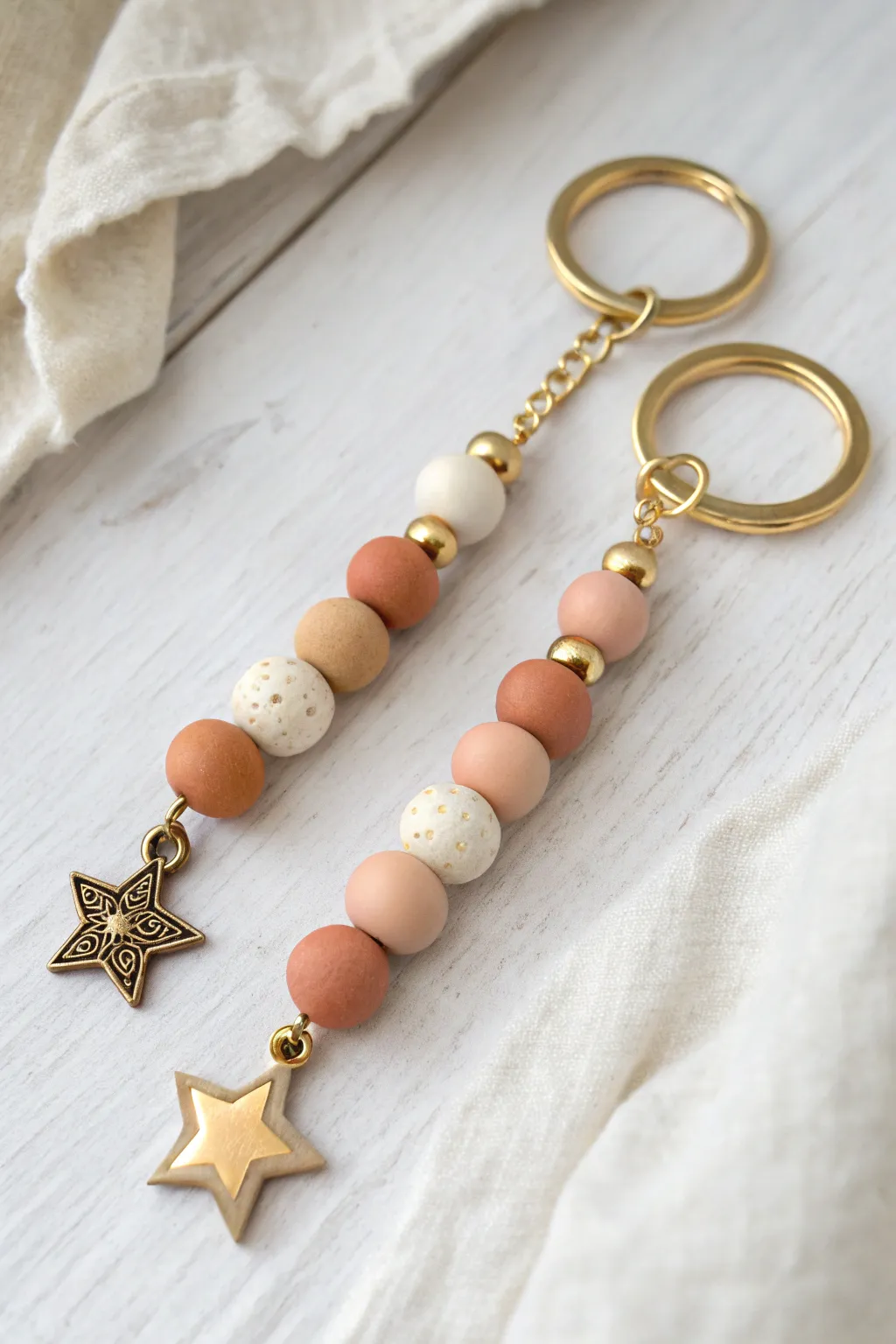 Friendship clay bead keychain duo with matching tones, simple charms, and minimalist styling