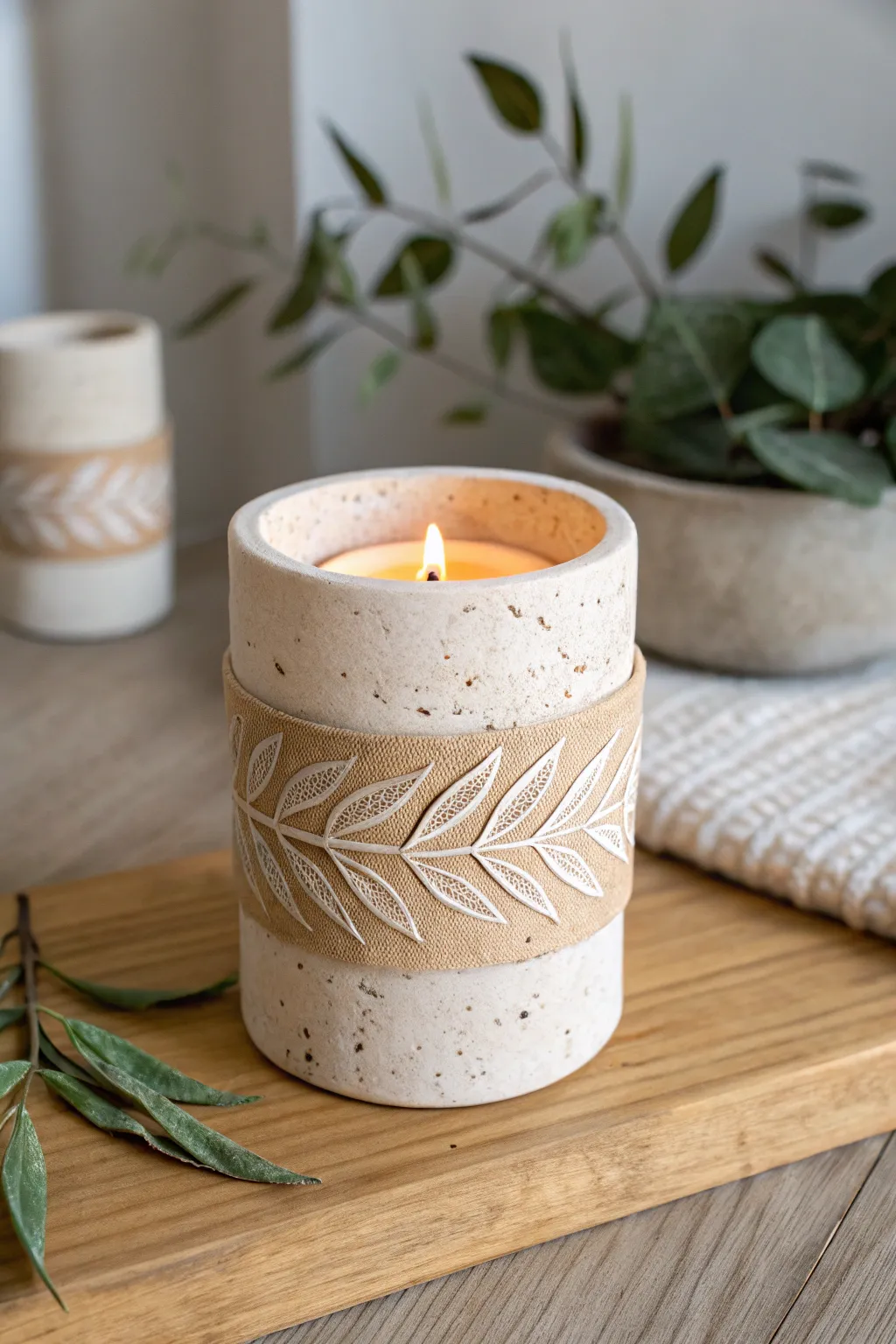 Leaf-imprint clay candle holder wrap in warm natural tones, minimalist boho glow for cozy corners.