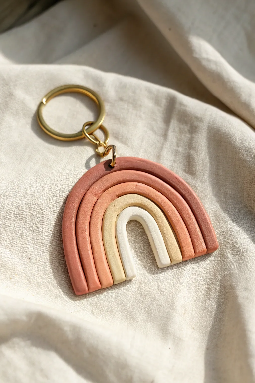Layered color-block clay keychain in soft earthy tones, minimalist and handmade charm.