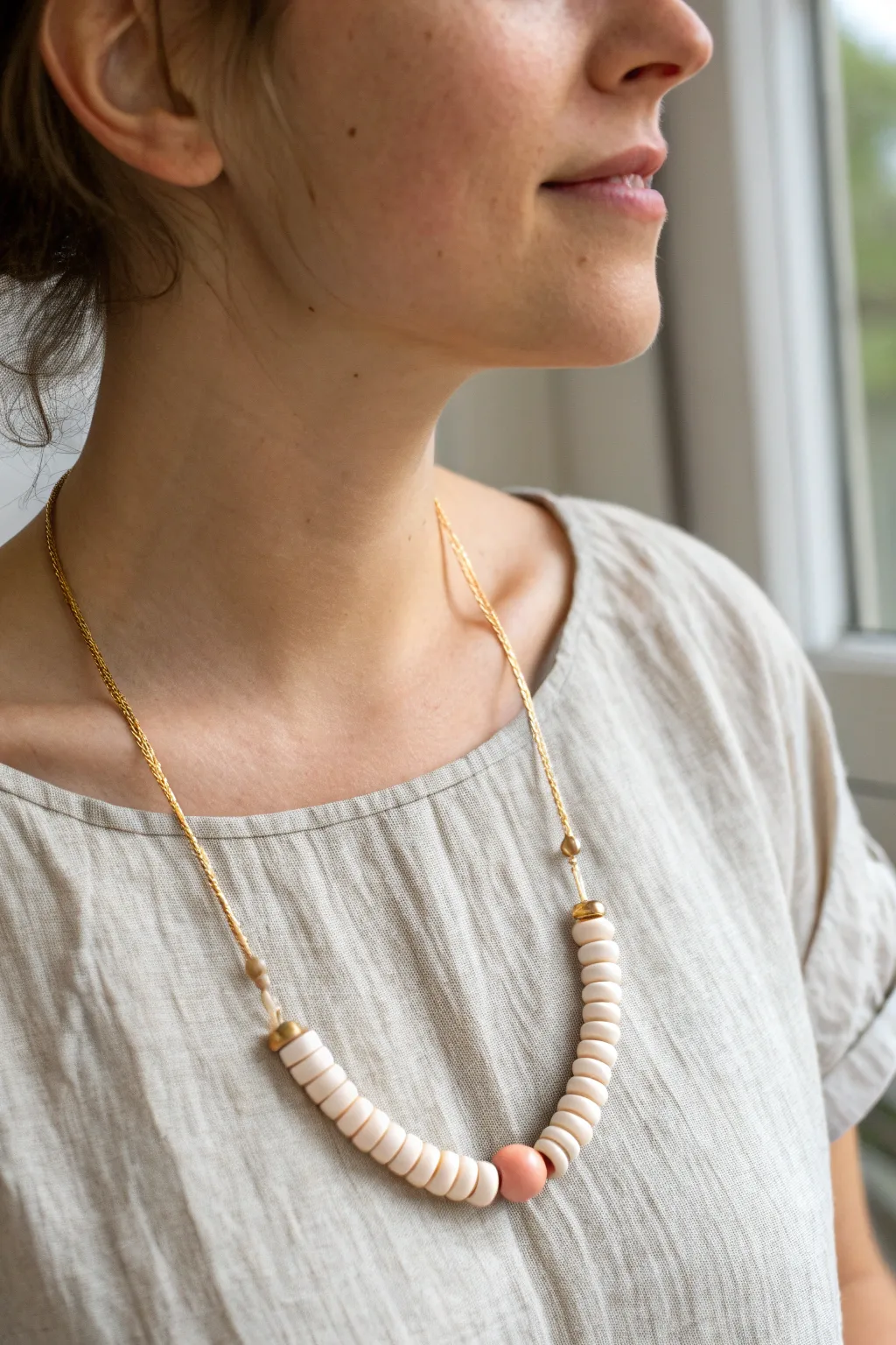 Sweet curved clay bar center and heishi ends, a simple boho-minimal necklace that sits perfectly.