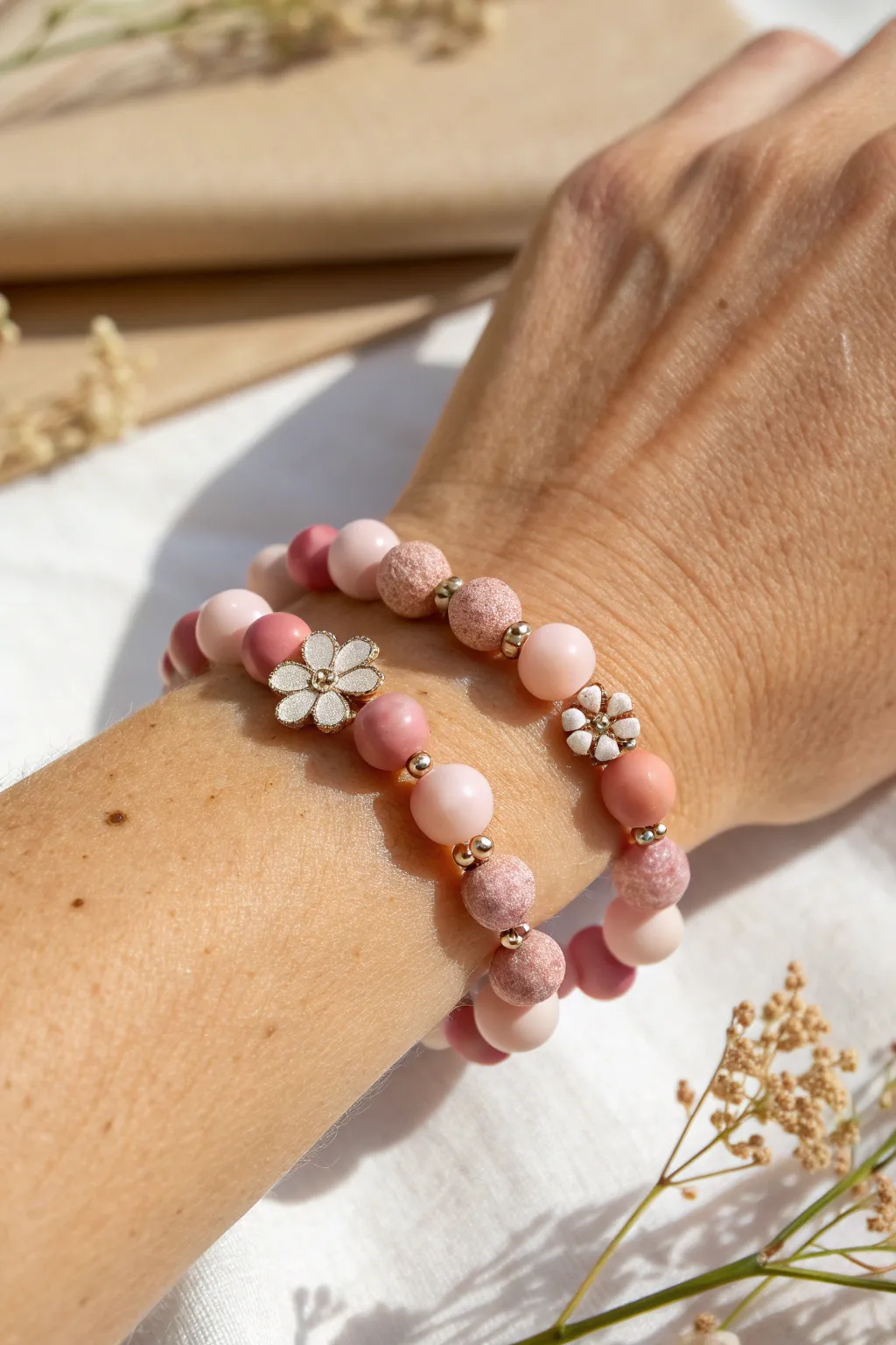Soft pink clay bead bracelet with tiny flower accents for a sweet, minimal boho look.