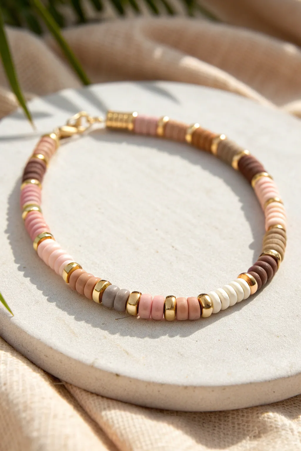 Character-coded heishi gradient bracelet with gold spacers for a polished, park-ready look