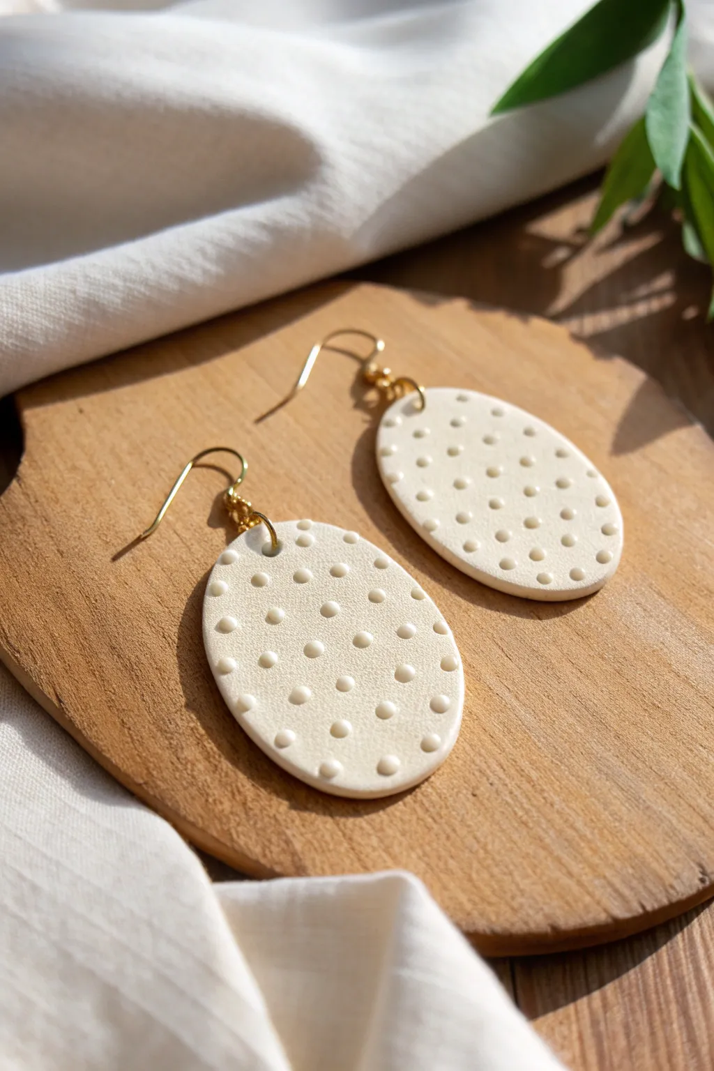 Raised dot oval clay earring statement piece, minimalist boho texture with crisp relief detail.