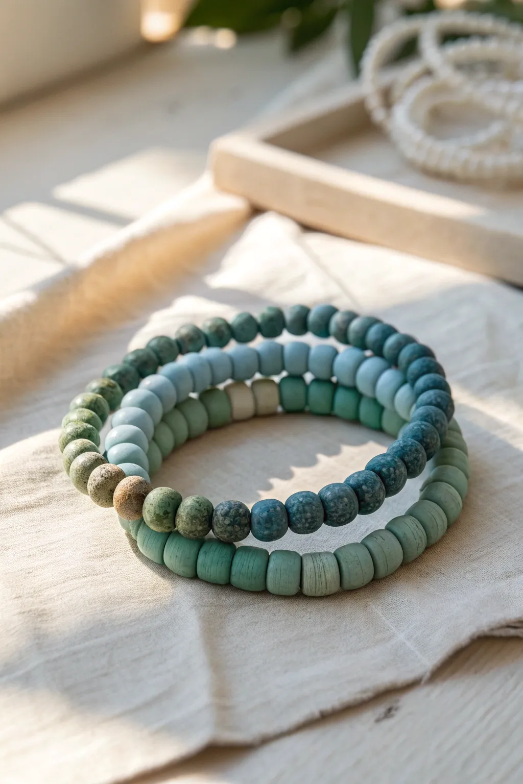 Succulent green gradient clay bracelet stack, from dusty sage to deep jade, simple and serene.