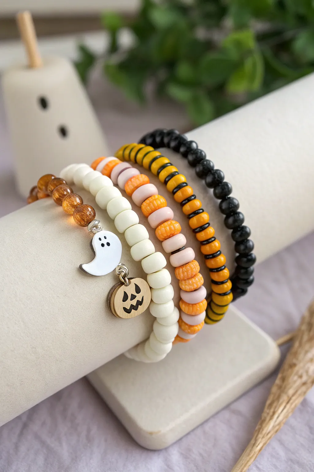 Five easy Halloween clay bead bracelets, each with its own spooky-cute vibe in one arm party stack.