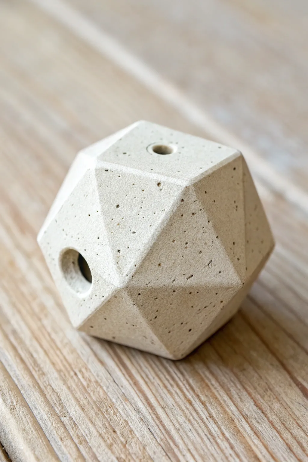 Geometric pinch whistle with carved facets, minimalist Scandinavian styling and soft boho warmth.