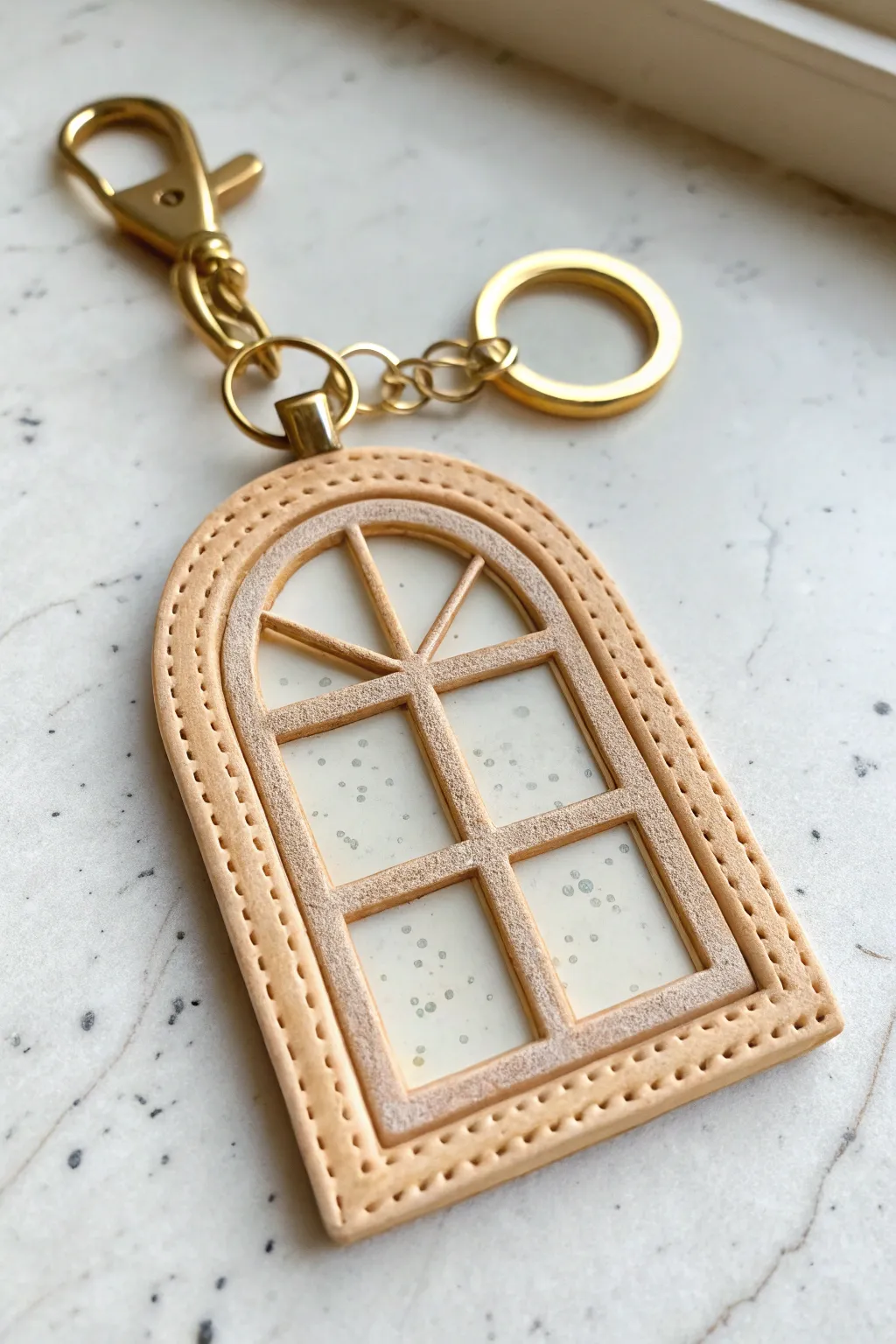 Minimal layered window keychain in polymer clay with see-through center and pastel pop.