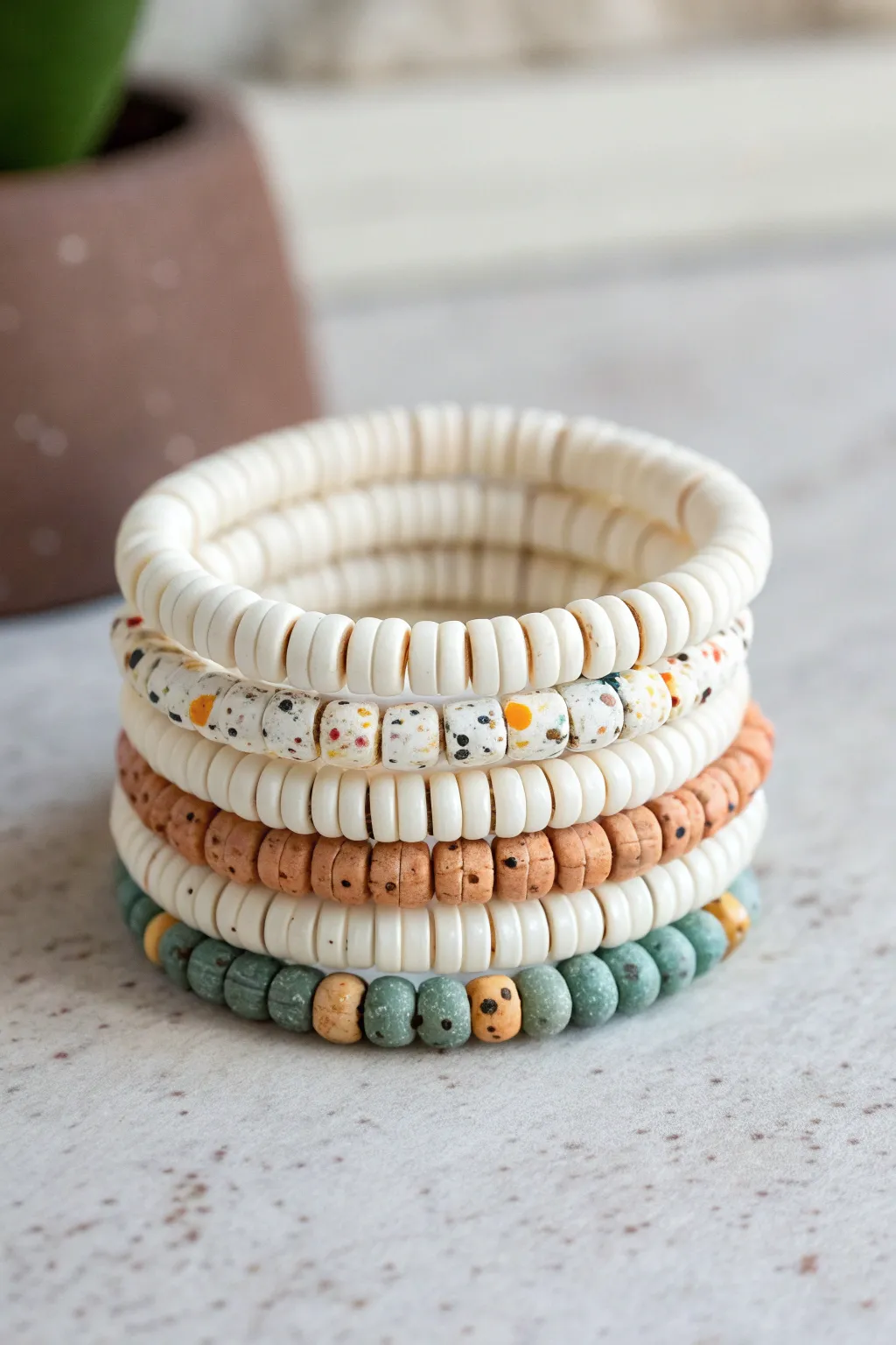 Terrazzo-speckled clay disc bead bracelet stack, creamy neutrals with joyful color pops
