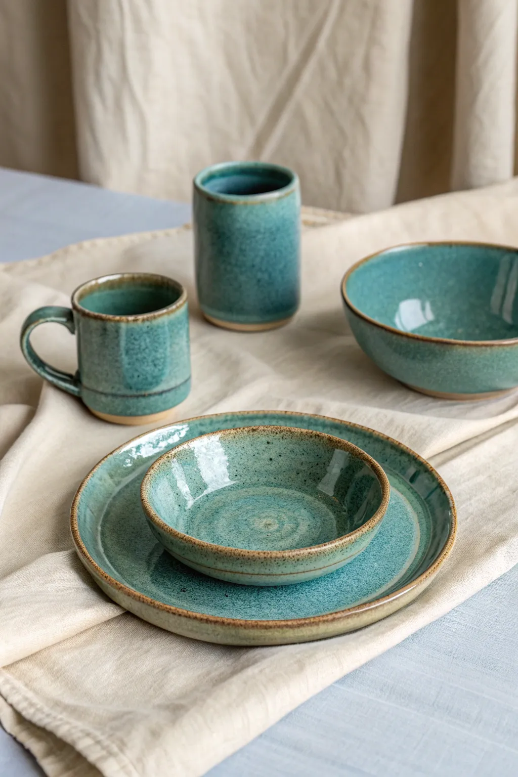 Three-piece mini set in blue-green glaze variations, styled like test tiles made wearable