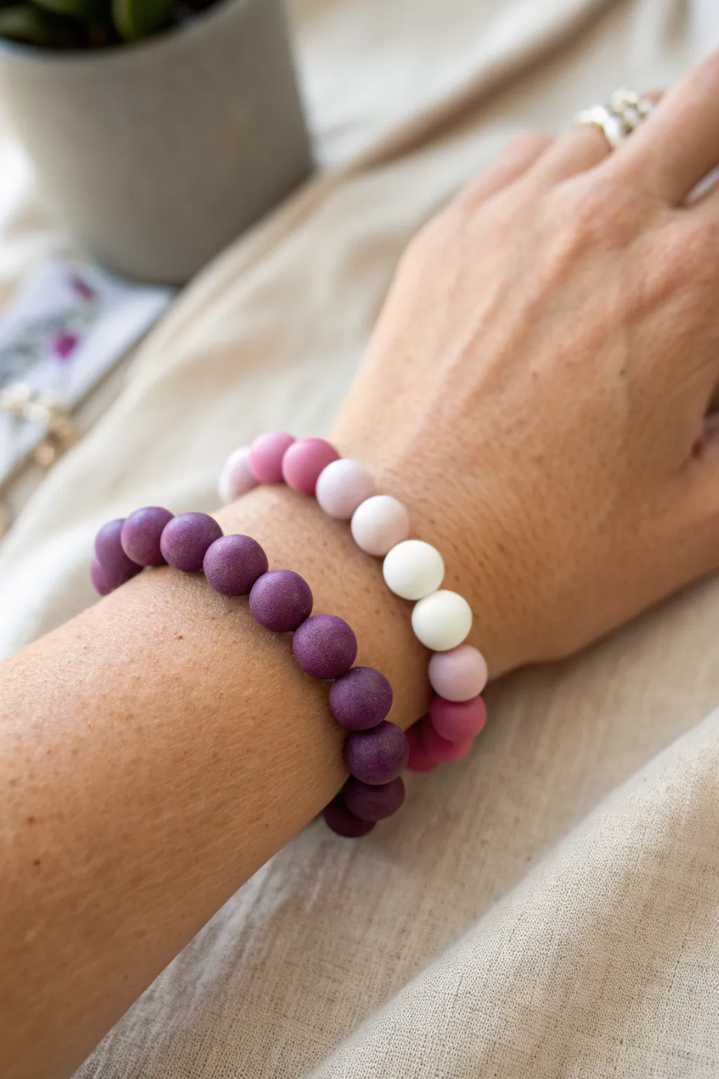 Sunset ombré bracelet: plum to lavender to pink, finished with crisp white clay beads.