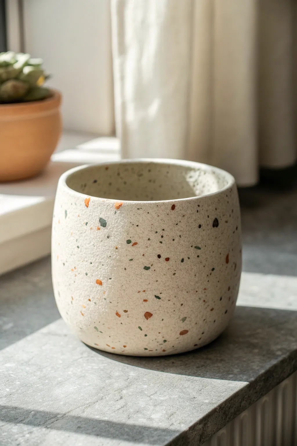 Faux terrazzo speckles turn a simple clay pot into a modern, minimalist statement piece.