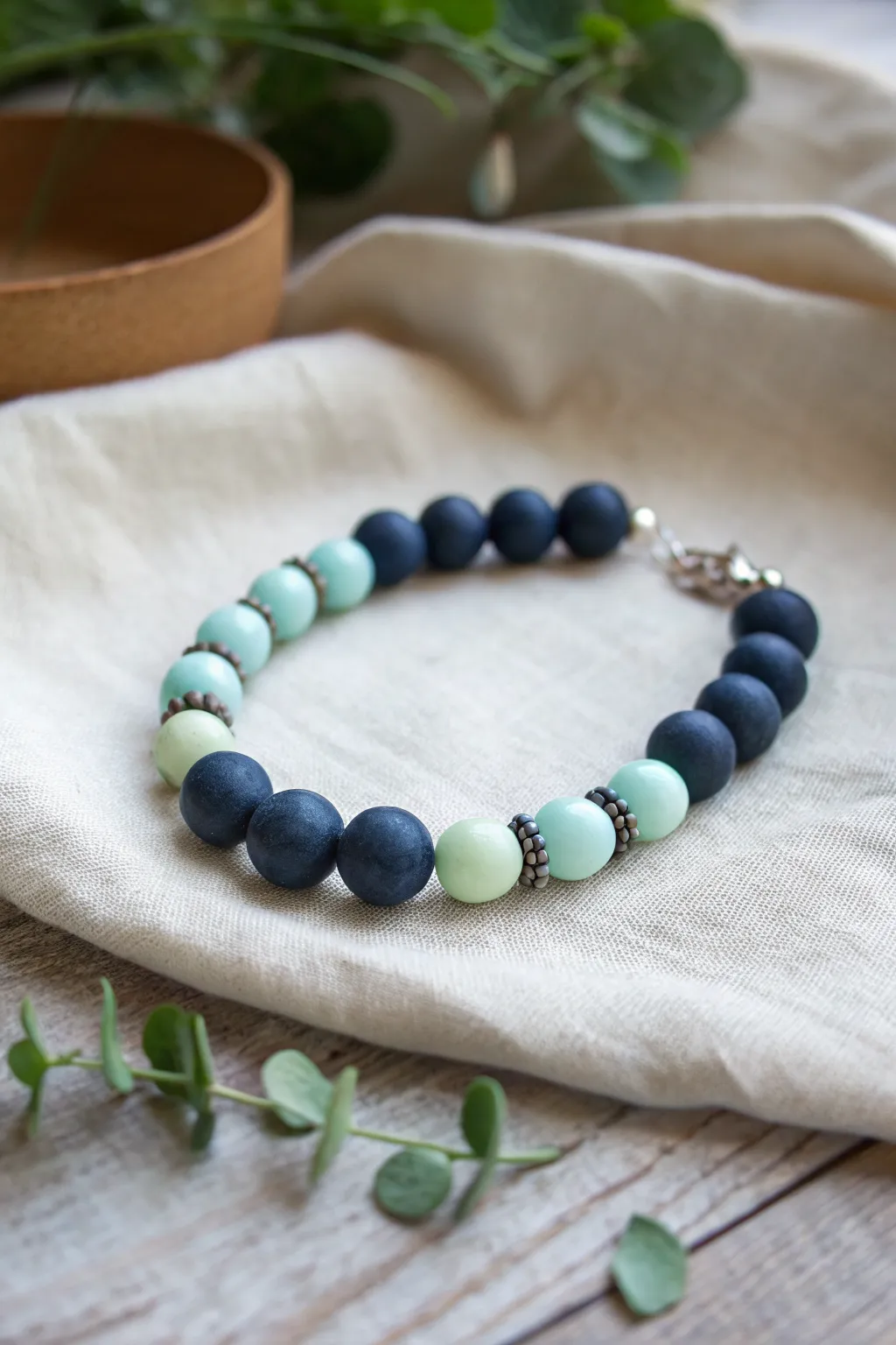 Deep blue stitch clay bracelet with subtle glow beads, styled in soft low light for night magic