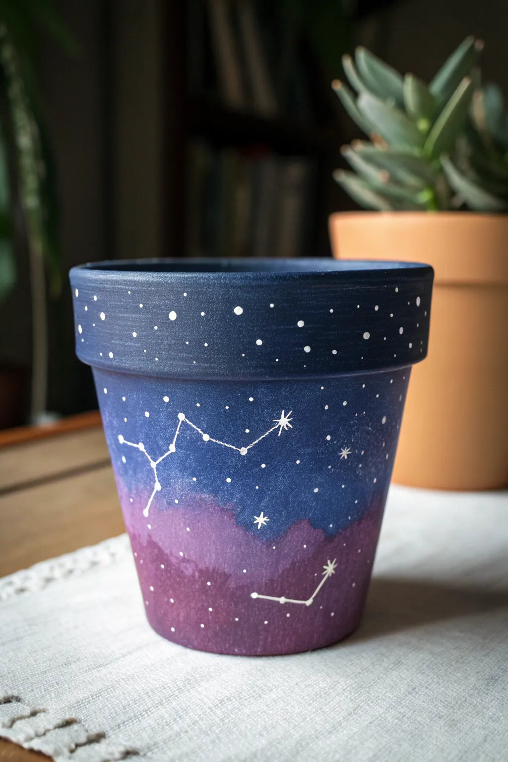 Galaxy terracotta pot with crisp constellation dots, moody light, and minimalist starry contrast.