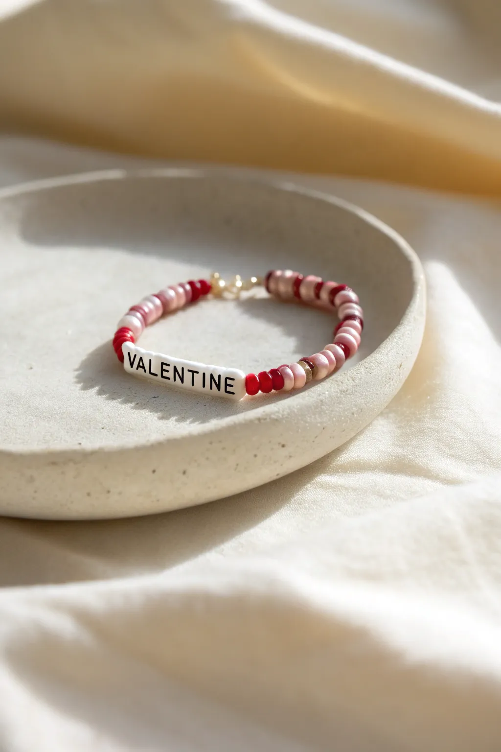 Minimal heishi bracelet with a tucked-in letter-bead message, a sweet hidden Valentine surprise.