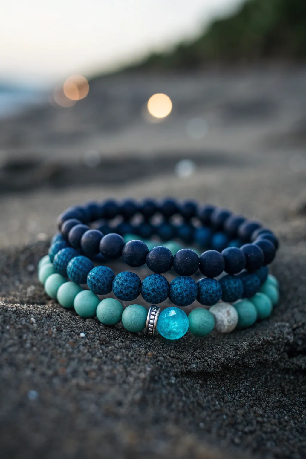 Deep navy and teal clay bead beach stack with subtle glow accents for midnight ocean vibes.