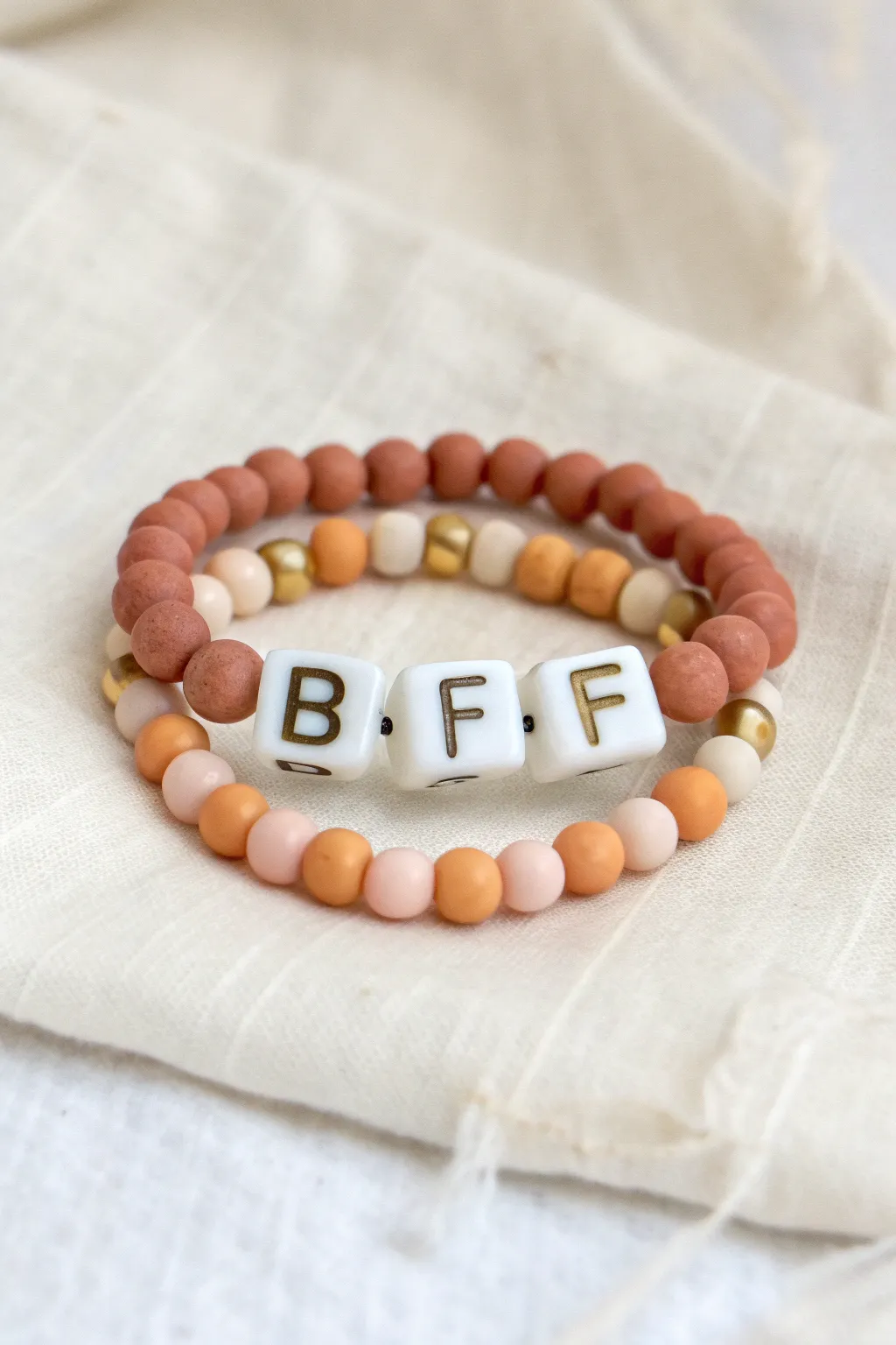 Minimal BFF clay bead bracelet pair with a hidden inner message, soft neutrals and boho charm.