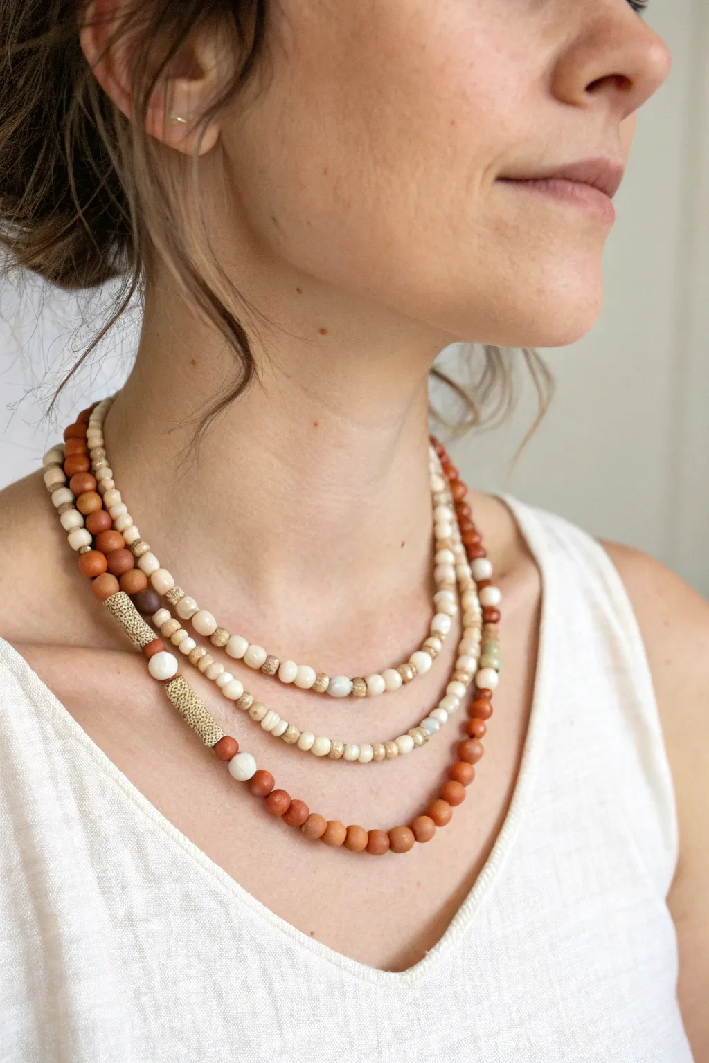 Two-strand clay bead choker in soft neutrals, minimalist Scandinavian style with a boho touch.