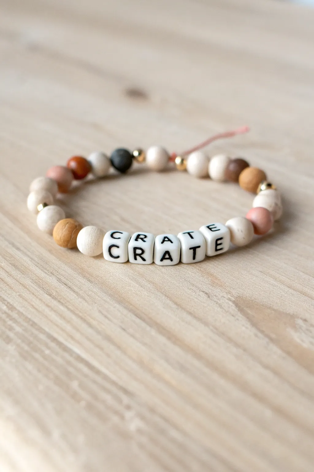 Neutral clay beads meet playful mixed-font letters for a minimalist boho statement bracelet.