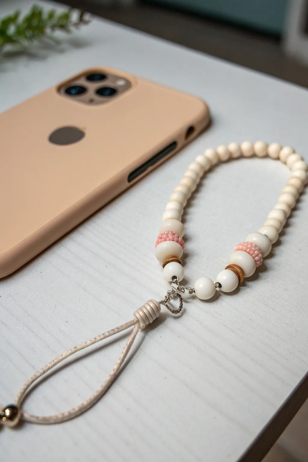 Glow-in-the-dark heishi clay bead phone charm that looks minimal by day and dreamy at night