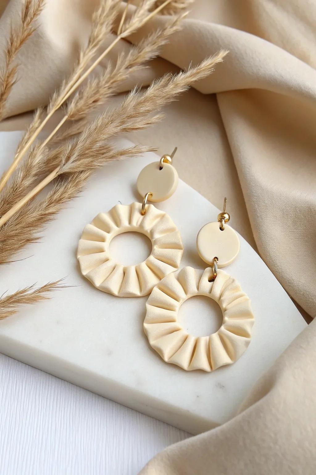 Minimalist clay ruffle dangles in a solid hue, styled to spotlight shape and dimension.