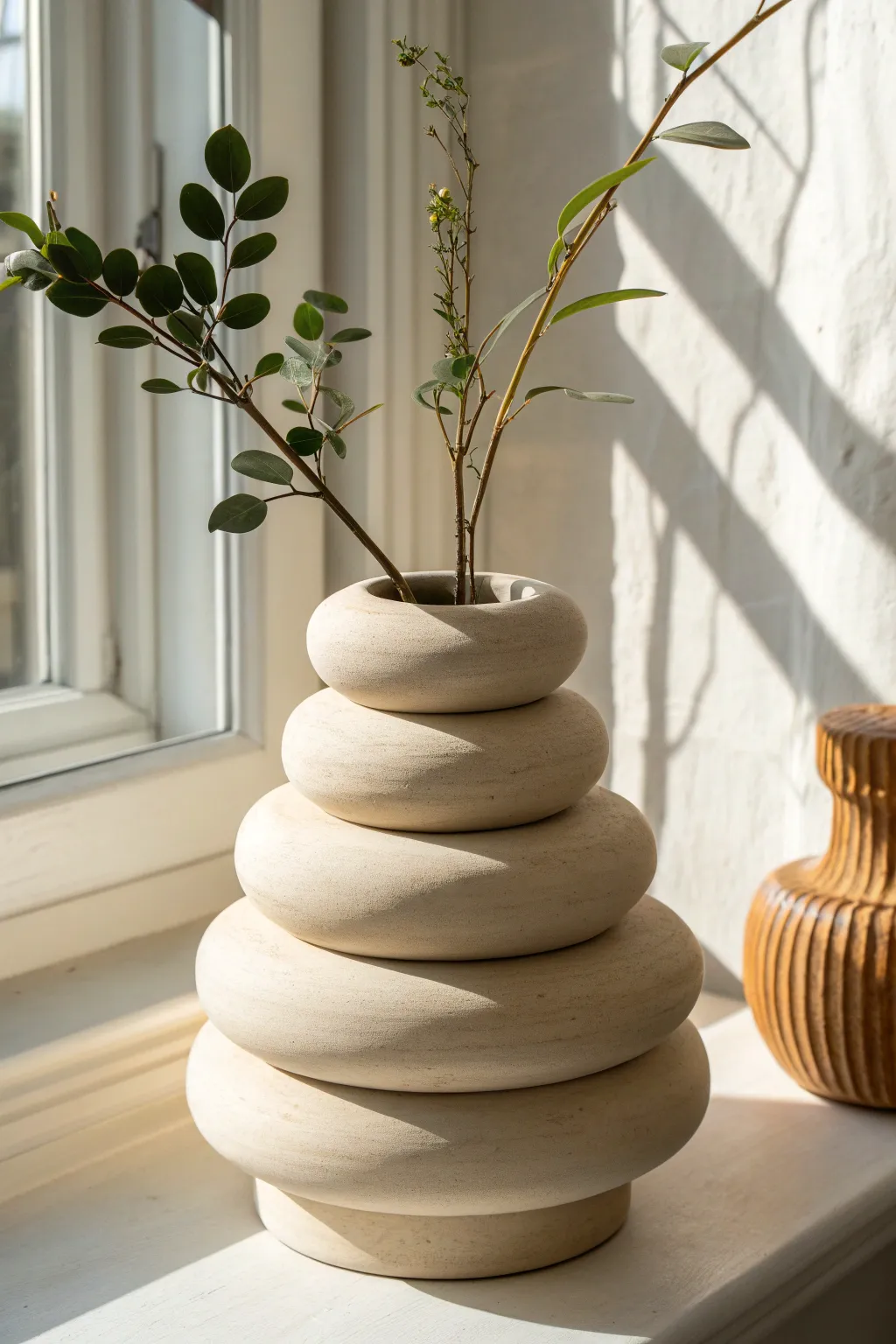 Easy stacked donut ring vase in matte sand tone, styled with one bold stem for modern boho charm.