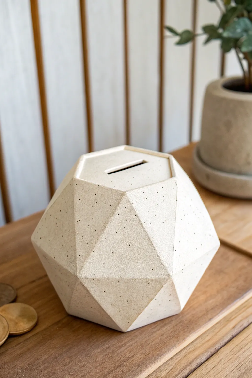 Modern faceted clay bank in matte sand tones, minimalist styling with crisp planes and contrast.