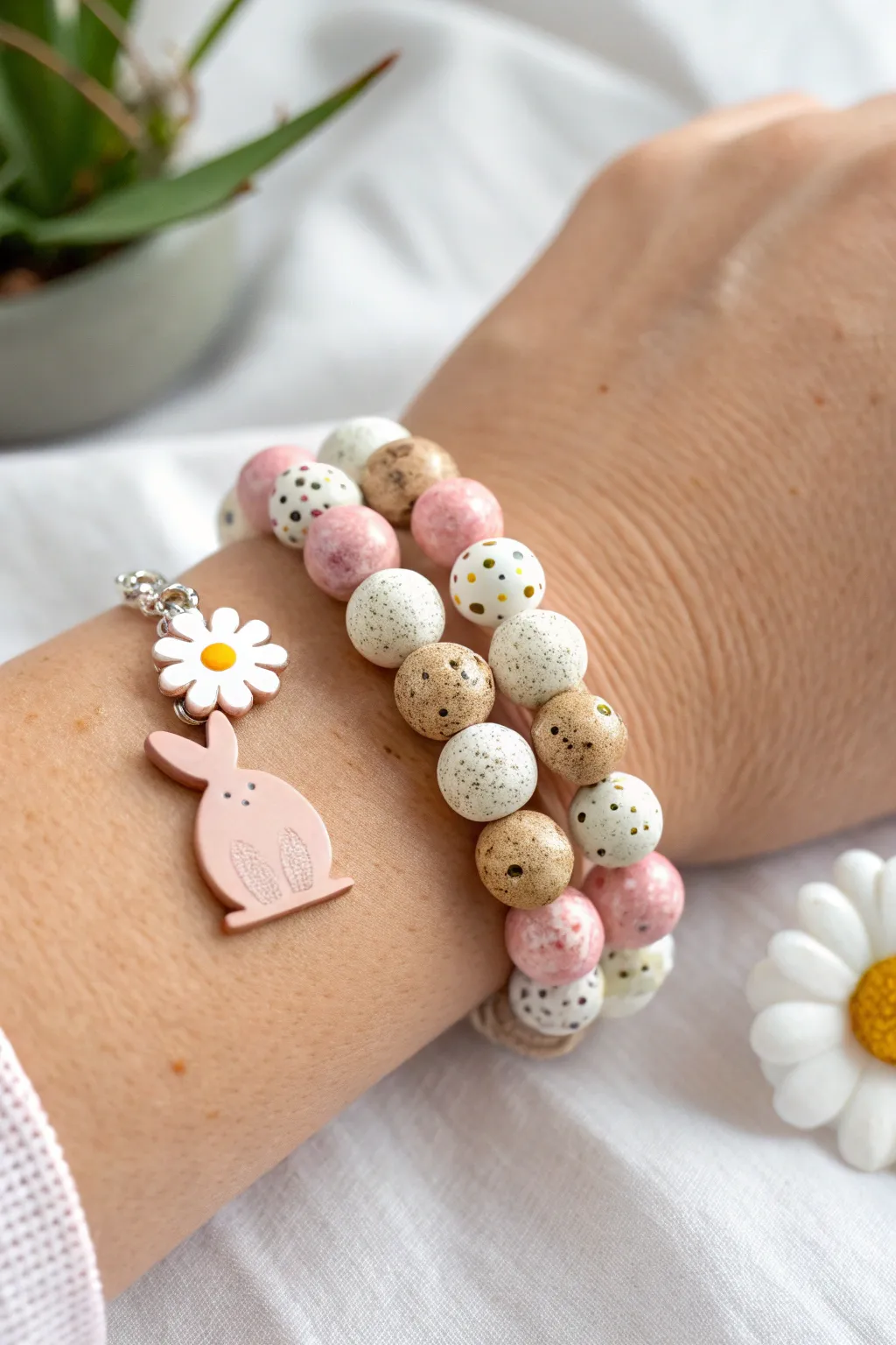 Pastel Easter clay bead bracelet stack with bunny, speckled egg, and sweet charm accents.