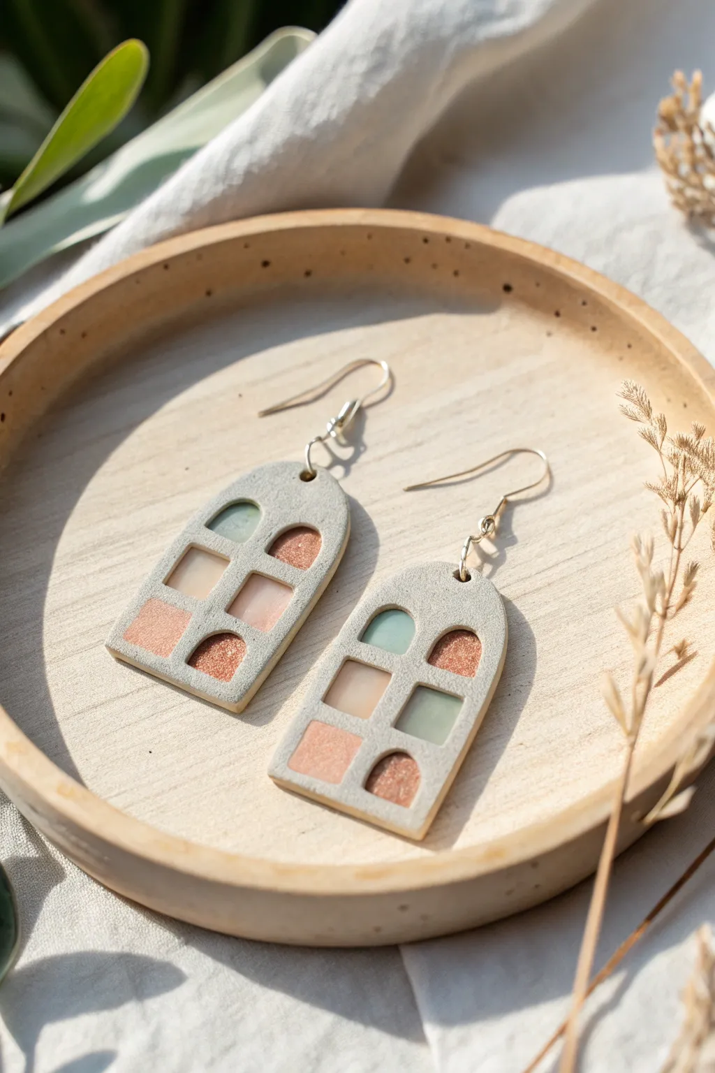 Layered polymer clay earrings with airy translucent windows for a soft, modern slab look.