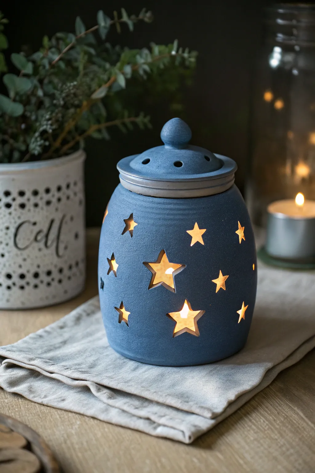 Midnight-blue star-punched luminary jar glowing softly for cozy kid-made night lights