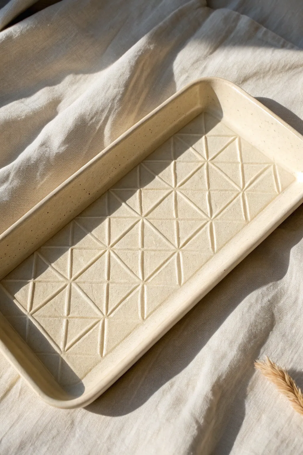 Stencil-pressed geometry adds crisp, modern texture with beautiful shadow play on a simple tray.