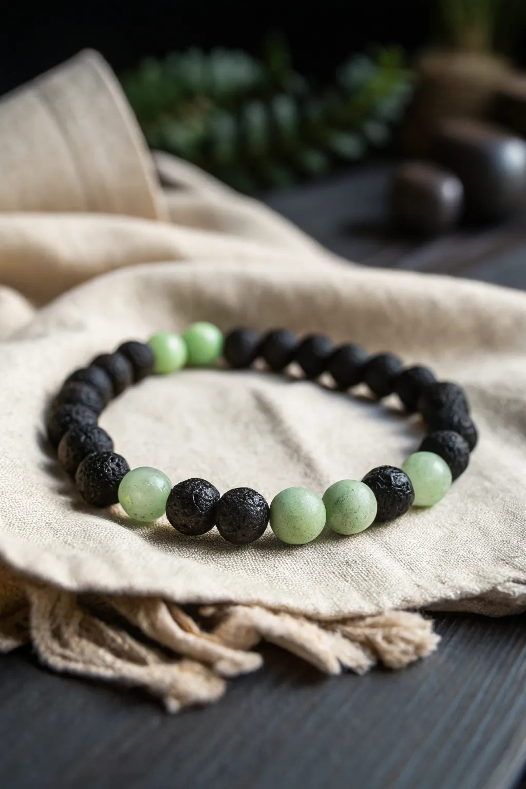 Moody green and black clay bead bracelet with a soft glow for calm, night-ready style.
