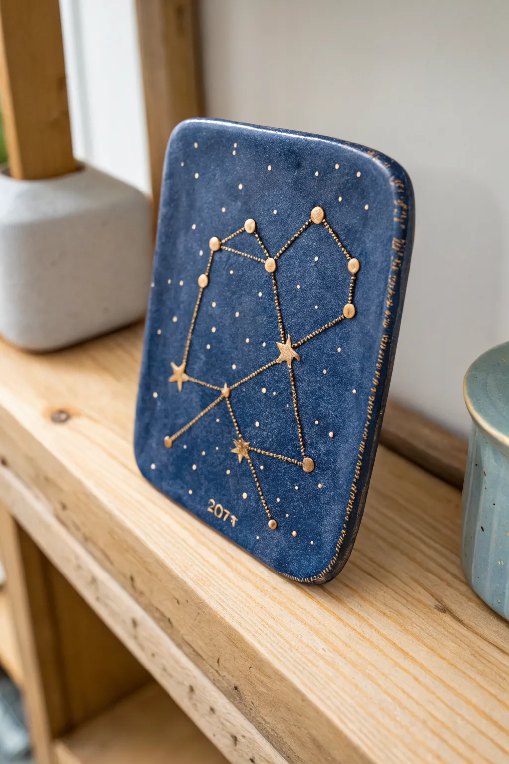 Craft a shared night sky in clay: a minimalist constellation plaque with moody light and bold indigo.