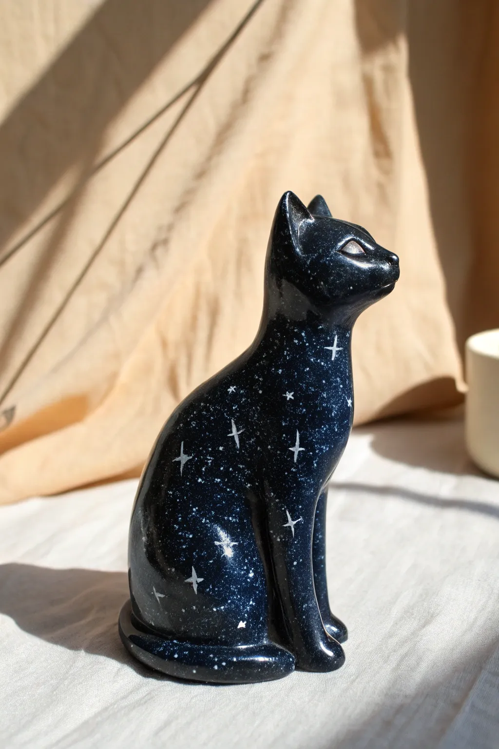 Starry Night Galaxy Cat: a sleek clay figurine with deep cosmic tones and tiny starlit speckles