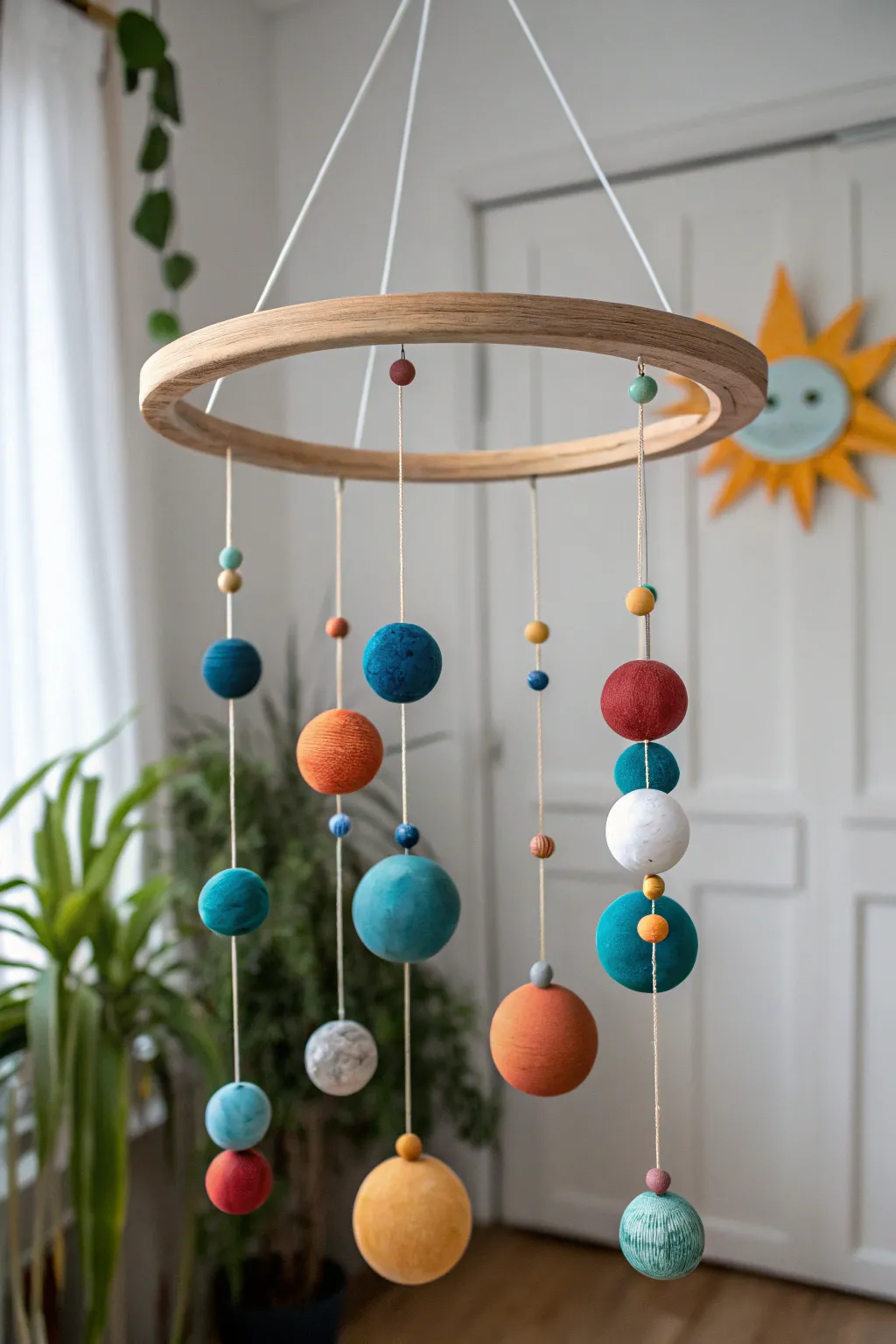 Puffy clay planets float on a simple hoop mobile for an easy, magical solar system decor.