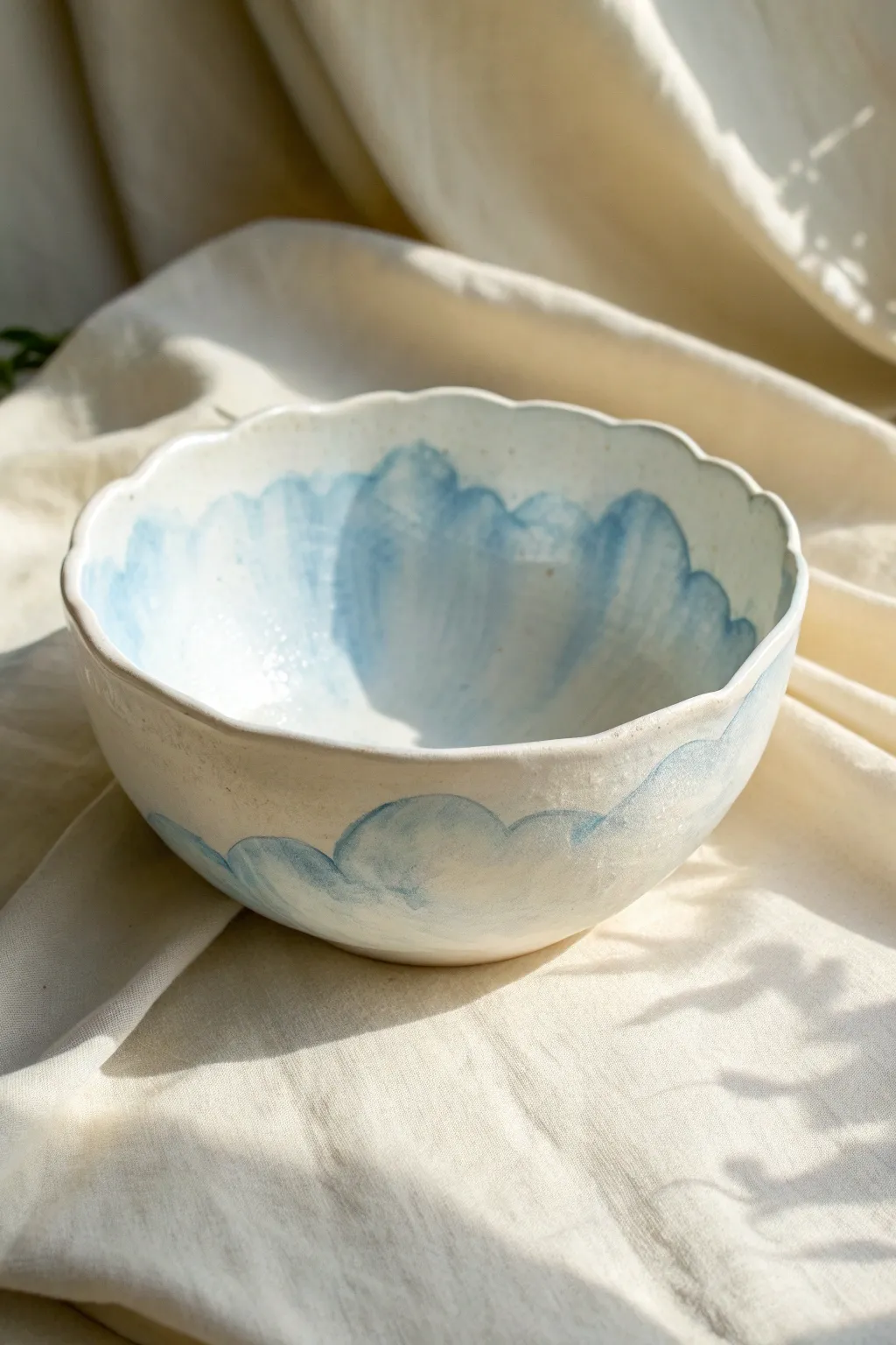 Dreamy cloud-shaped bowl in milky white with a soft sky-blue wash for airy minimalist charm.
