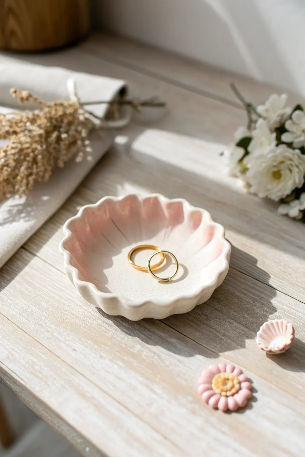 Soft scalloped ring dish in blush clay on light wood, minimal boho charm for jewelry