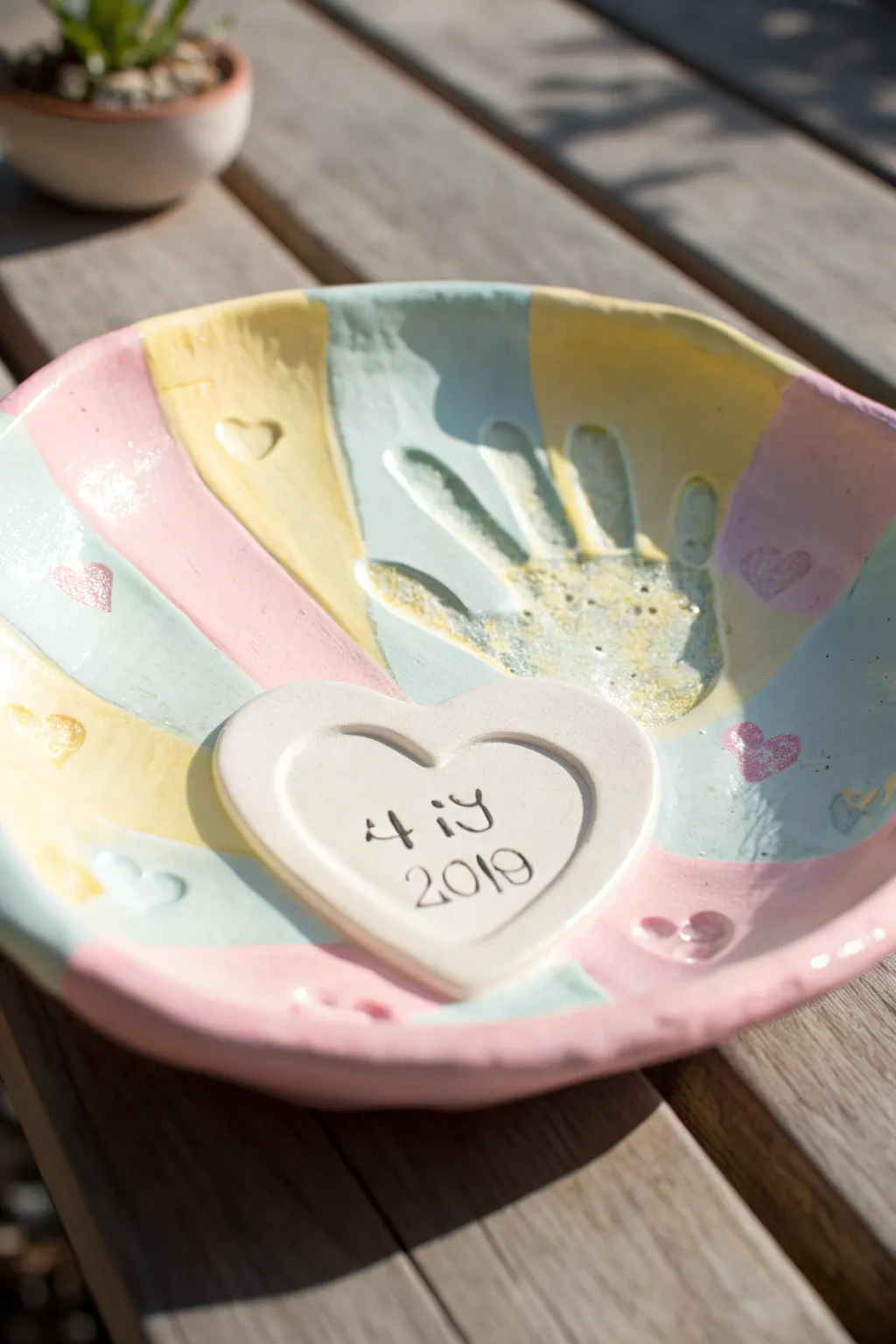 Sweet handprint keepsake dish in pastel tones, perfect air dry clay craft for kids.