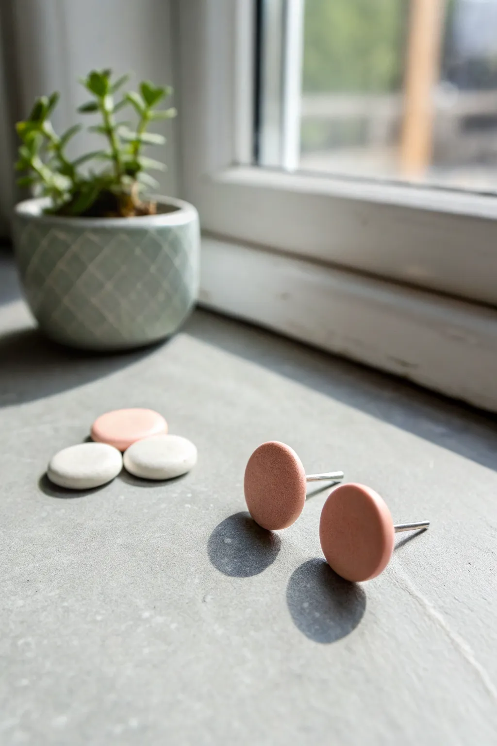 Simple air-dry clay studs in blush, sage, and white for an elegant minimalist jewelry idea.