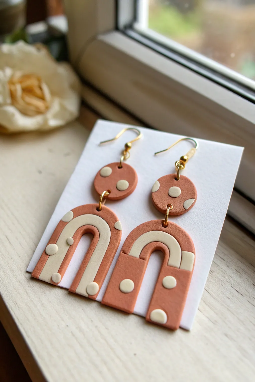 Matte geometric baked clay earrings in modern earthy tones, styled minimal for a chic look