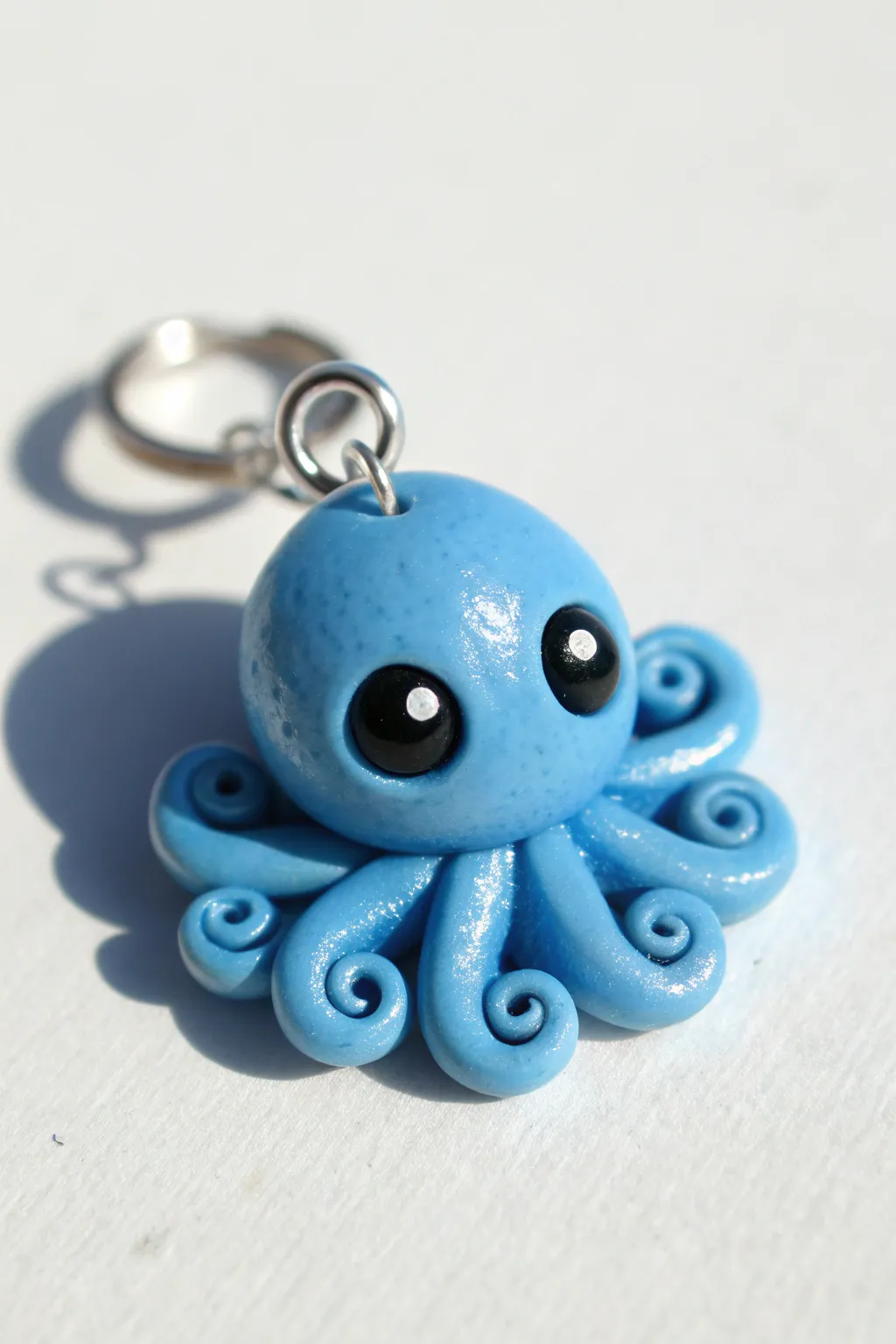 A sweet blue octopus charm with big eyes and curled tentacles for easy, cute clay projects.