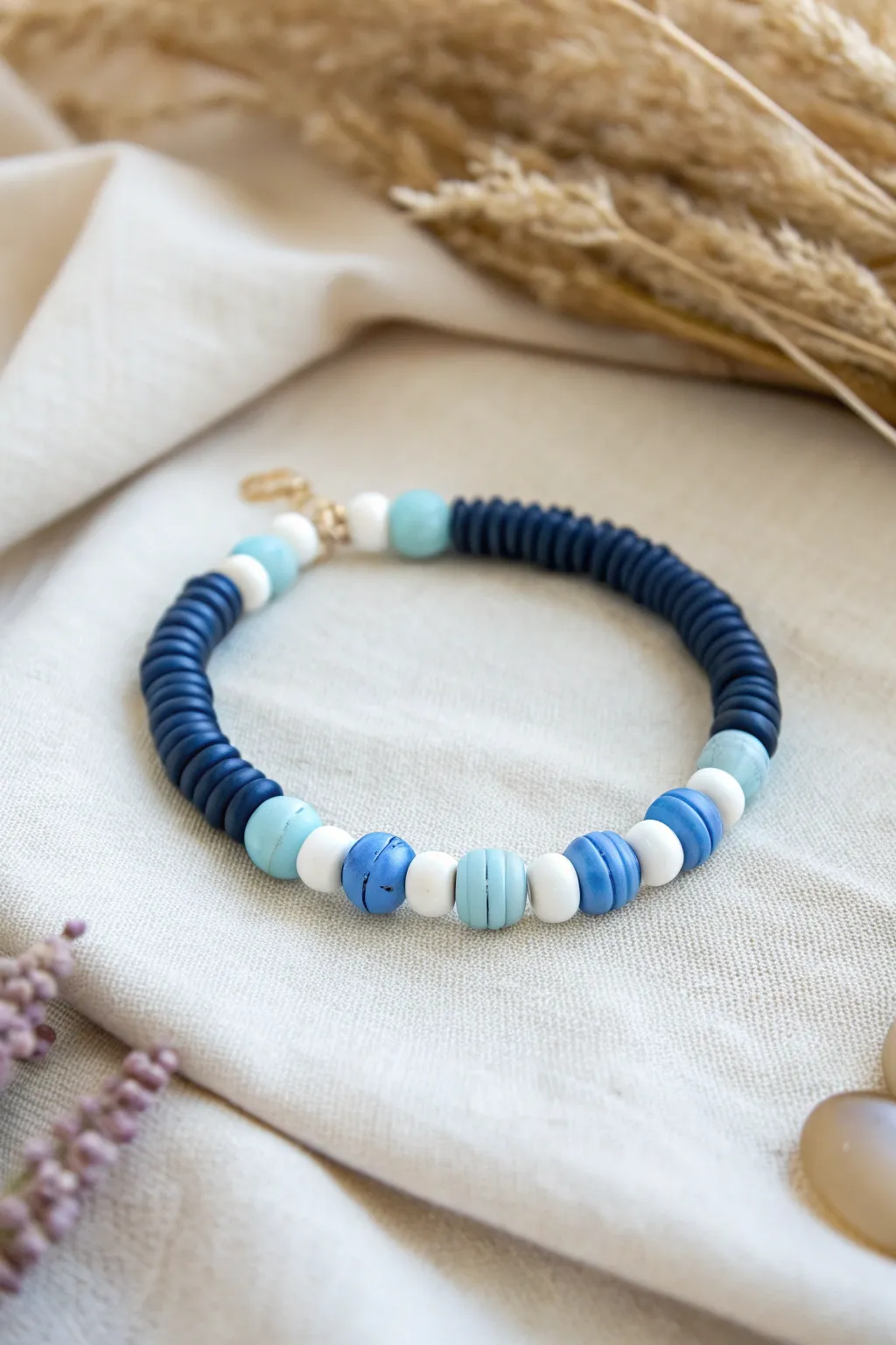Navy, white, and sky blue heishi bracelet flat lay for a crisp coastal color block vibe