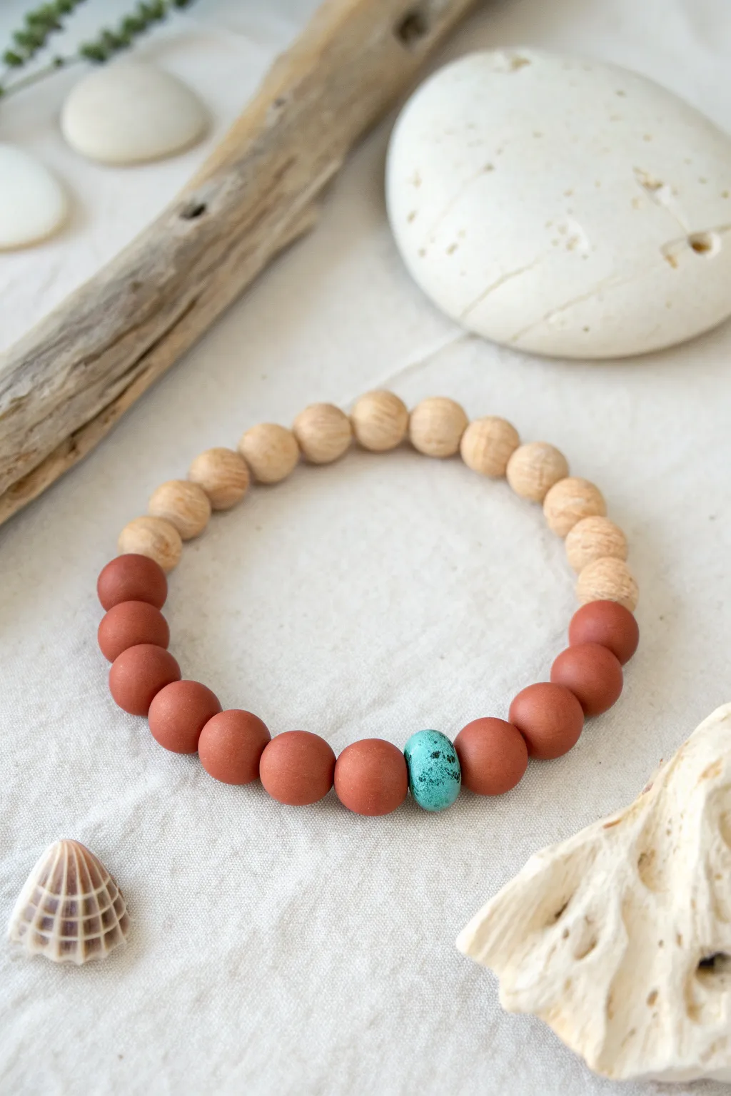 Warm neutrals with a muted turquoise center for an easy boho bracelet that feels calm and coastal.