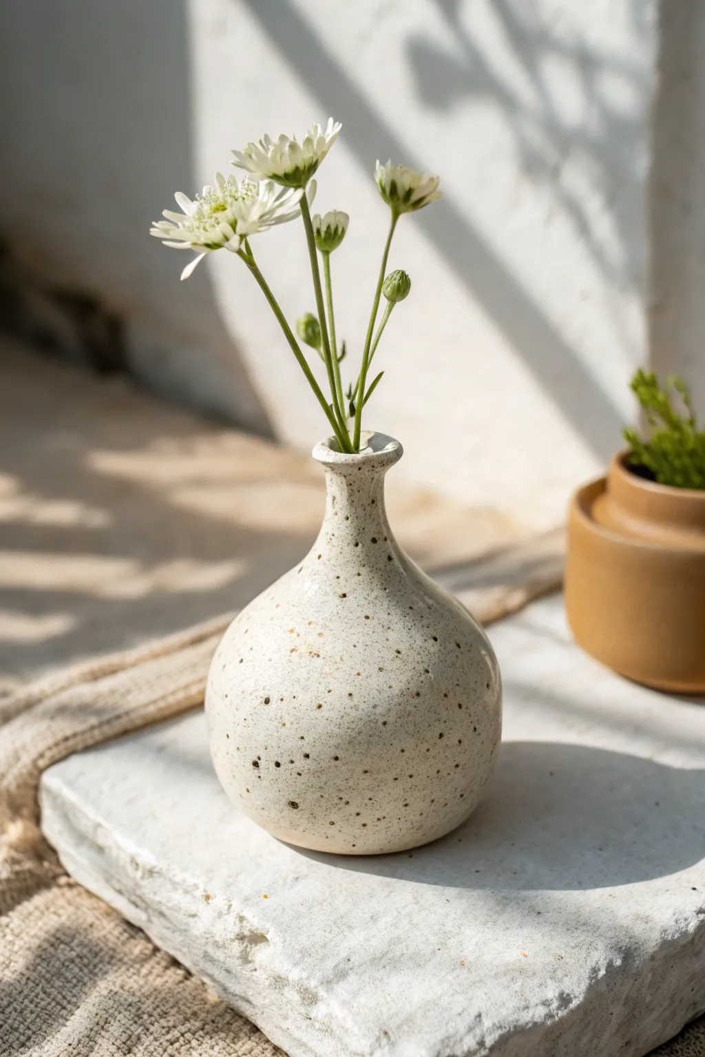 A simple bottle-neck bud vase idea that highlights one stem with calm Scandinavian-boho charm.