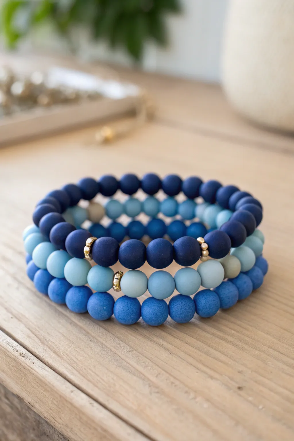 Blue ombre clay bead bracelet stack from navy to sky blue, minimalist and softly sunlit.