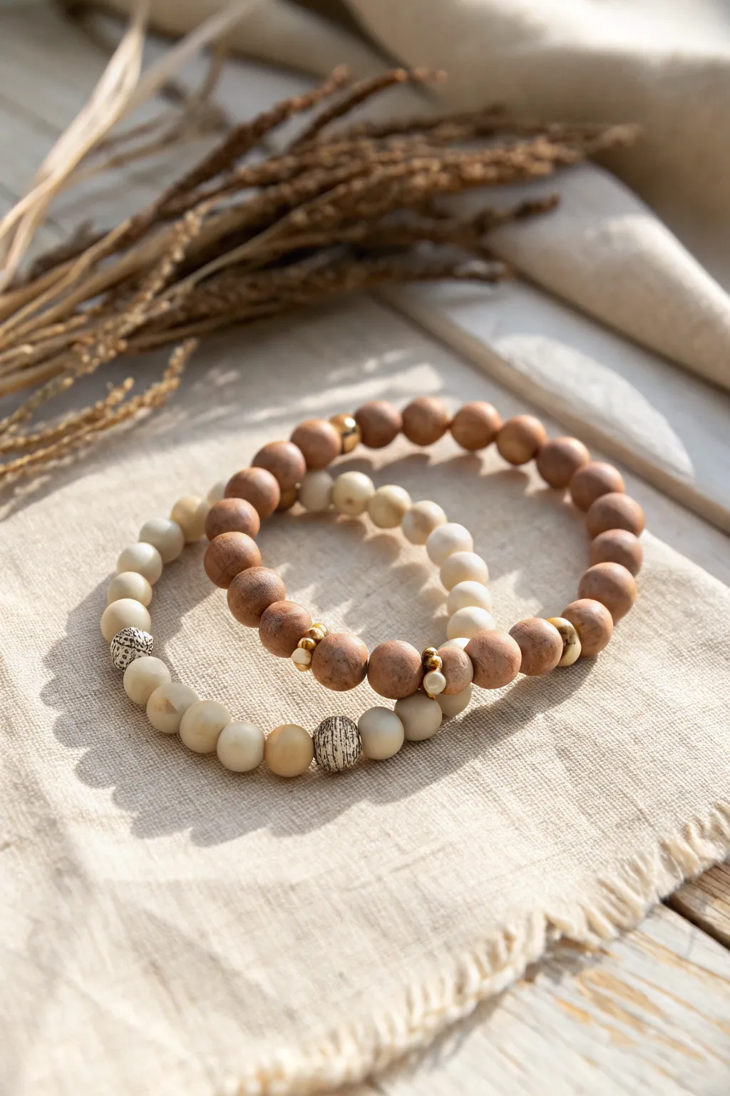 Neutral clay bead bracelet stack in cream and tan, minimal everyday style with subtle metallic accents