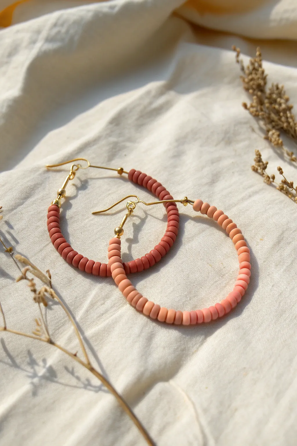 Minimal ombre heishi hoop earrings in warm terracotta-to-blush tones, simple and handmade.