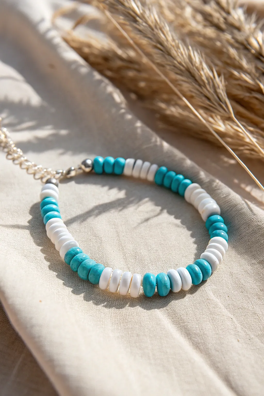 Ocean-inspired clay disc bracelet in turquoise and white, minimal Scandinavian styling, beachy calm.