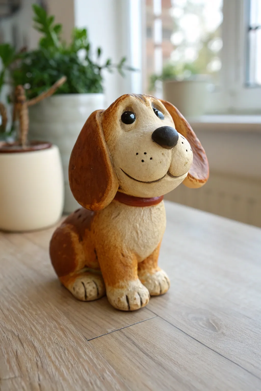 Sweet floppy-ear puppy clay bobblehead in warm neutrals, minimal and handmade charm