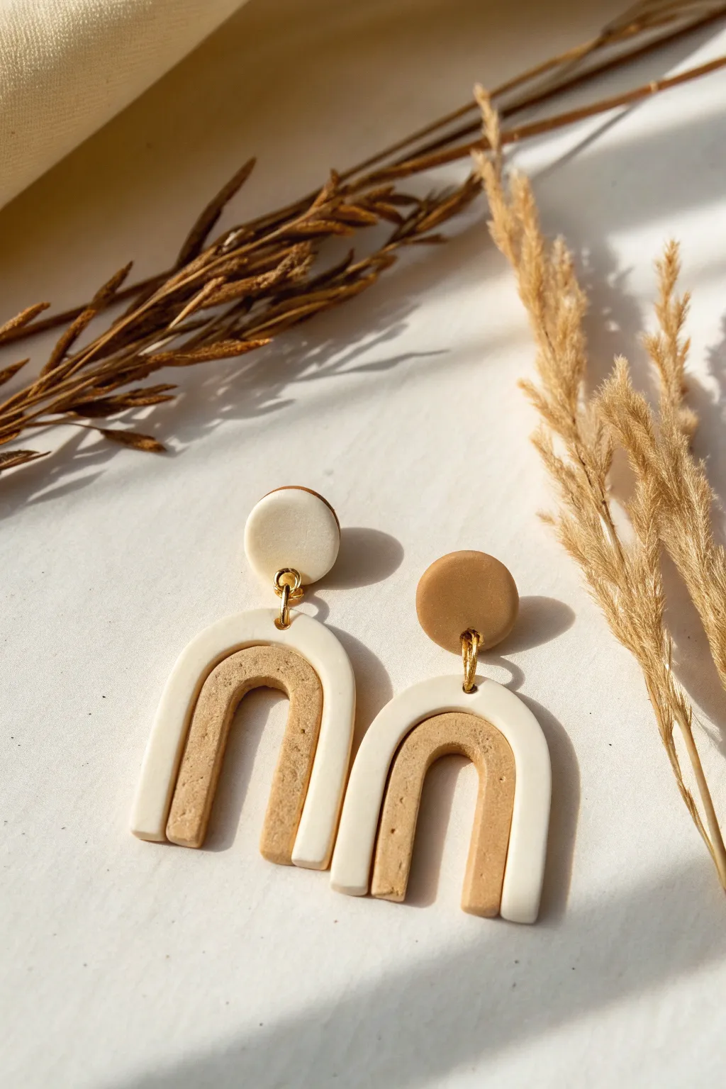 Mini arch clay dangles in warm neutrals, a simple beginner-friendly shape with modern boho charm.